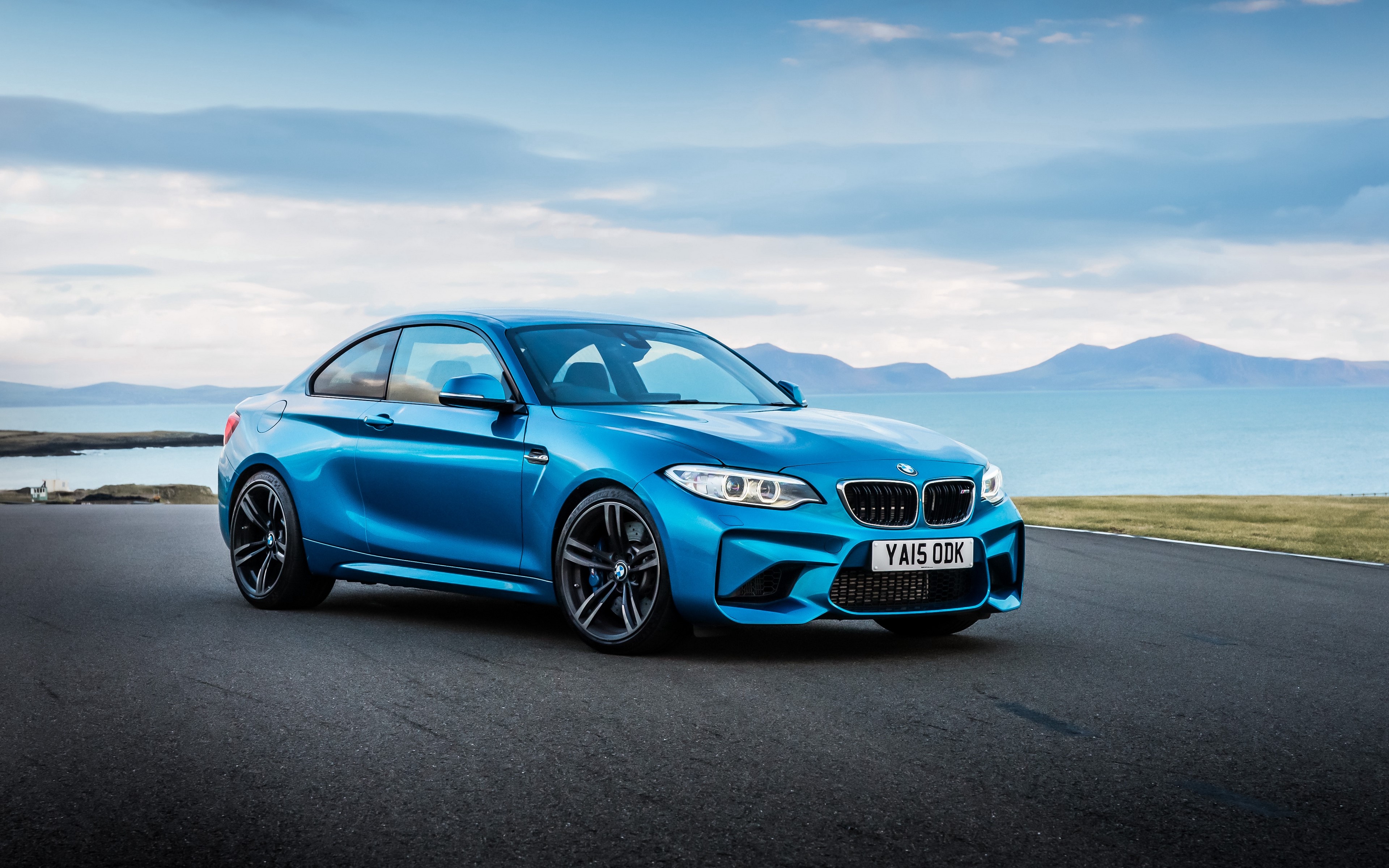 Blue BMW M2 on a Road by the Water HD Wallpaper