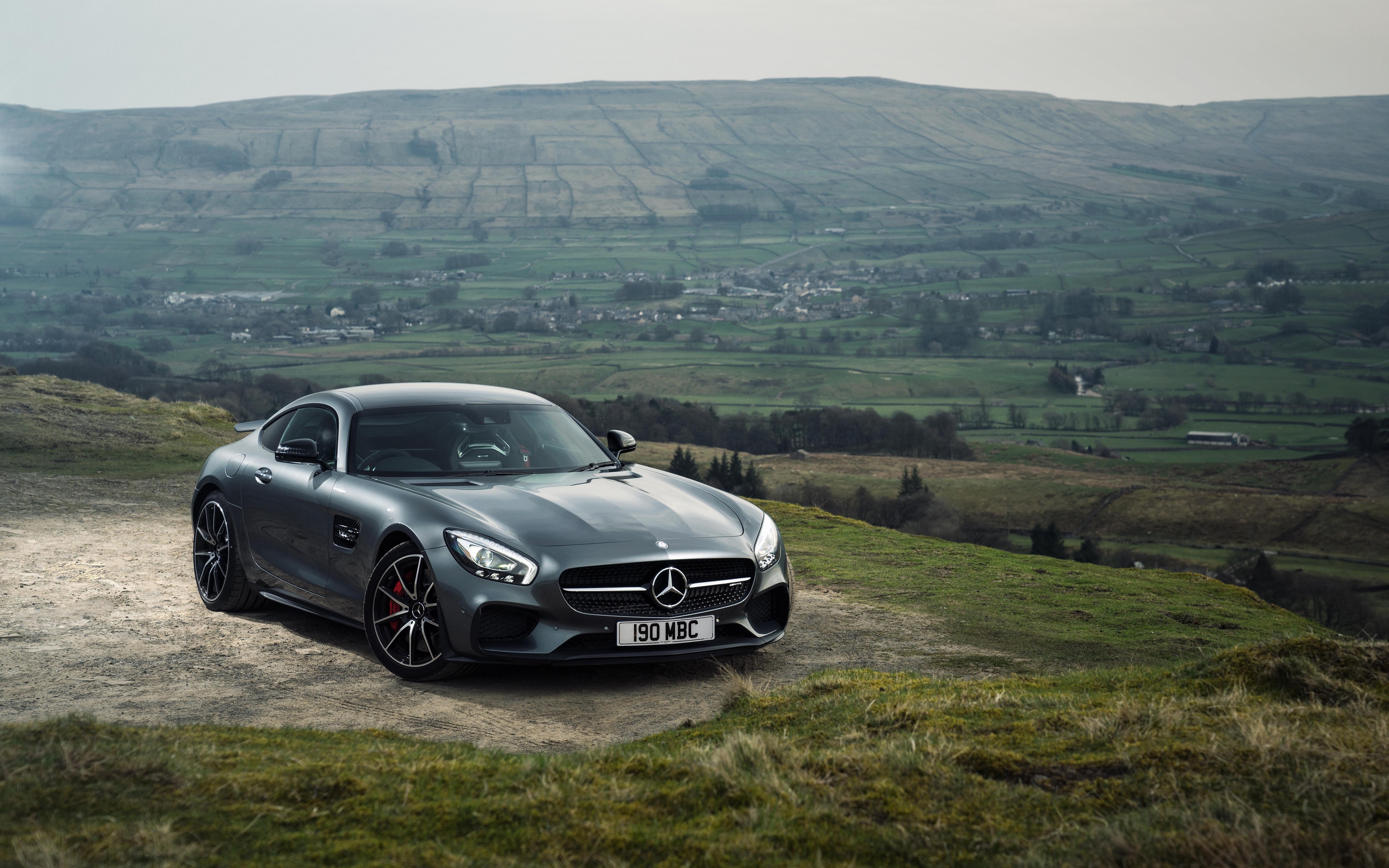 Mercedes AMG GTs on a hill with a valley landscape HD Wallpaper