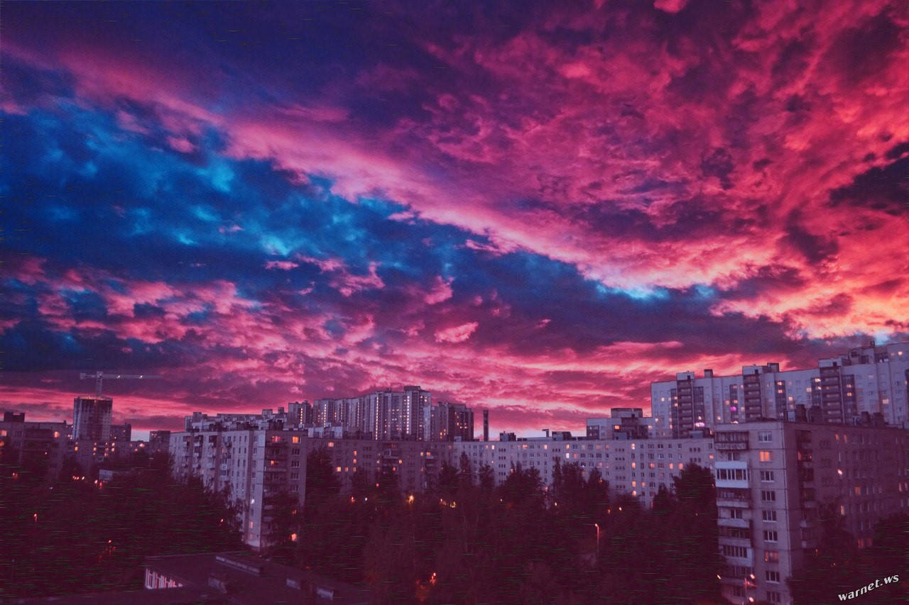 Colorful clouds over a city at night HD Wallpaper