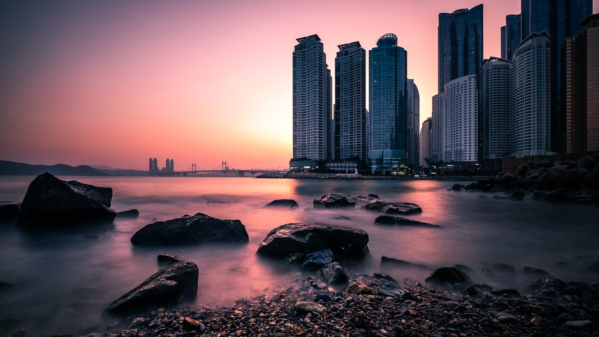 Cityscape with skyscrapers and bridge at sunset HD Wallpaper