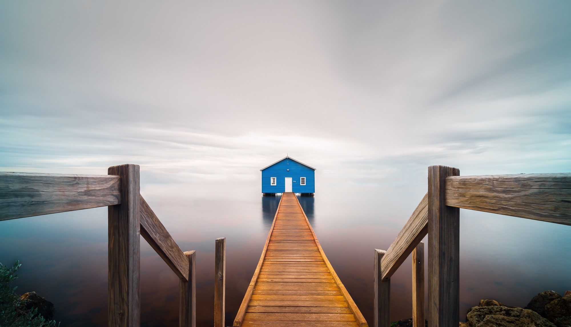 Blue house on a pier over calm water HD Wallpaper