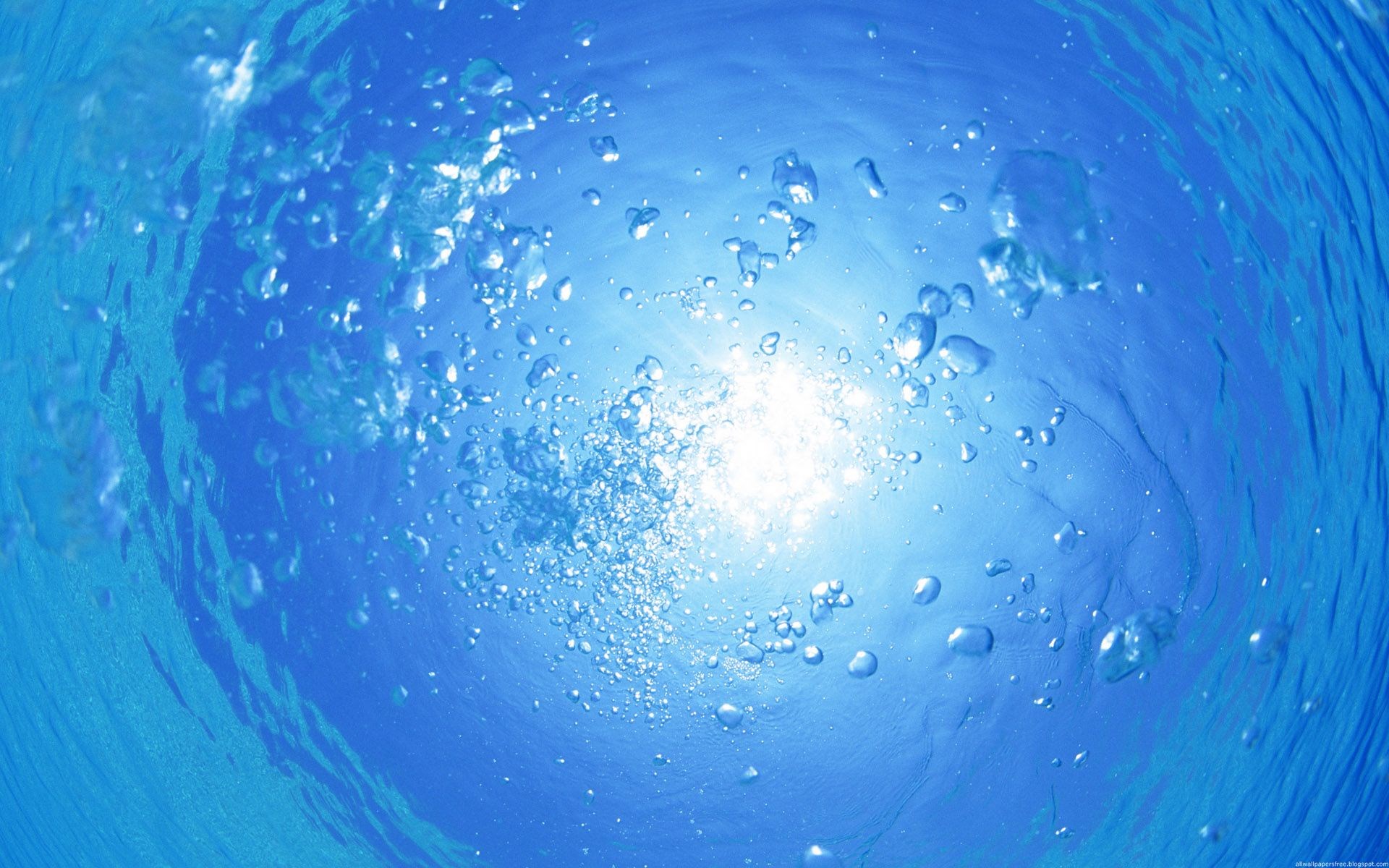 Bubbles rising in blue water towards the sun HD Wallpaper