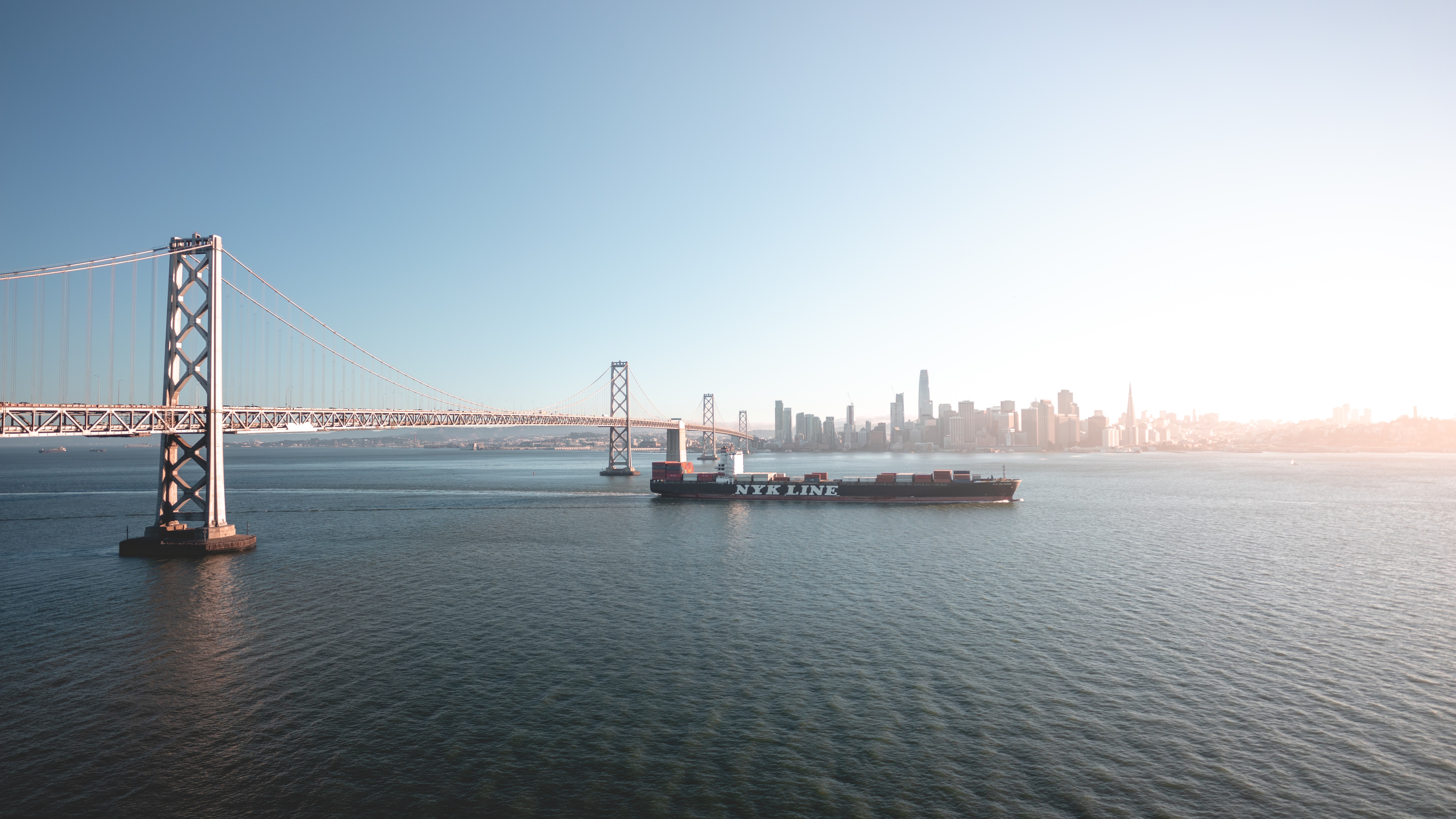 Container ship passes under San Francisco Bay Bridge HD Wallpaper