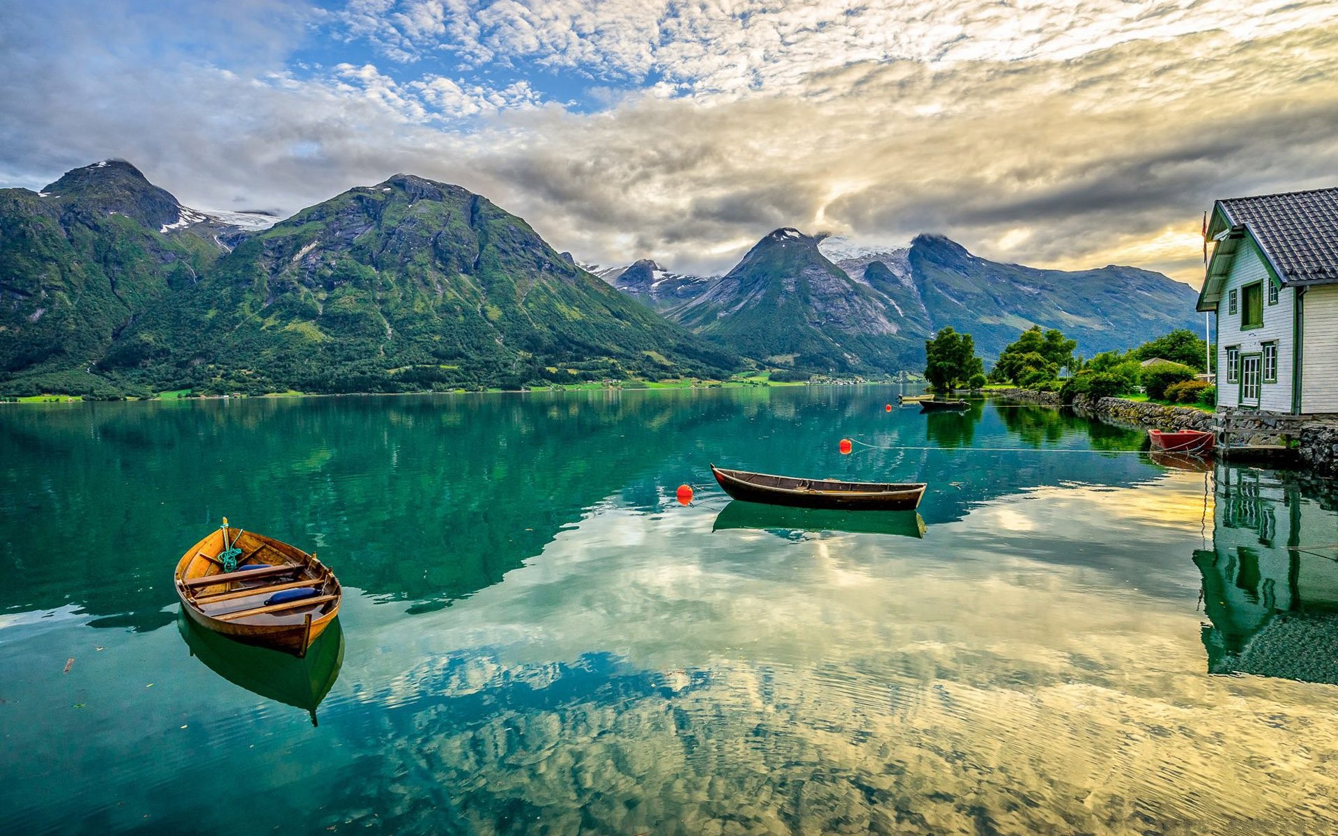 Boats on a lake with mountains and clouds HD Wallpaper